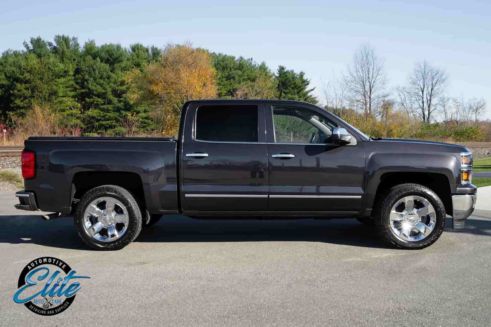 a black pick up truck parking outside